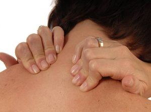 women with back and neck ache rubbing both shoulders isolated on white